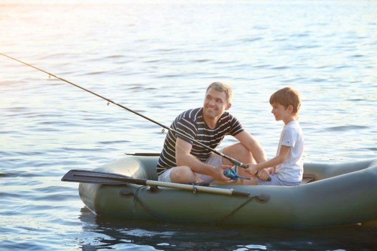 father-and-son-going-fishing-on-a-green-inflatable-boat-768x512.jpg